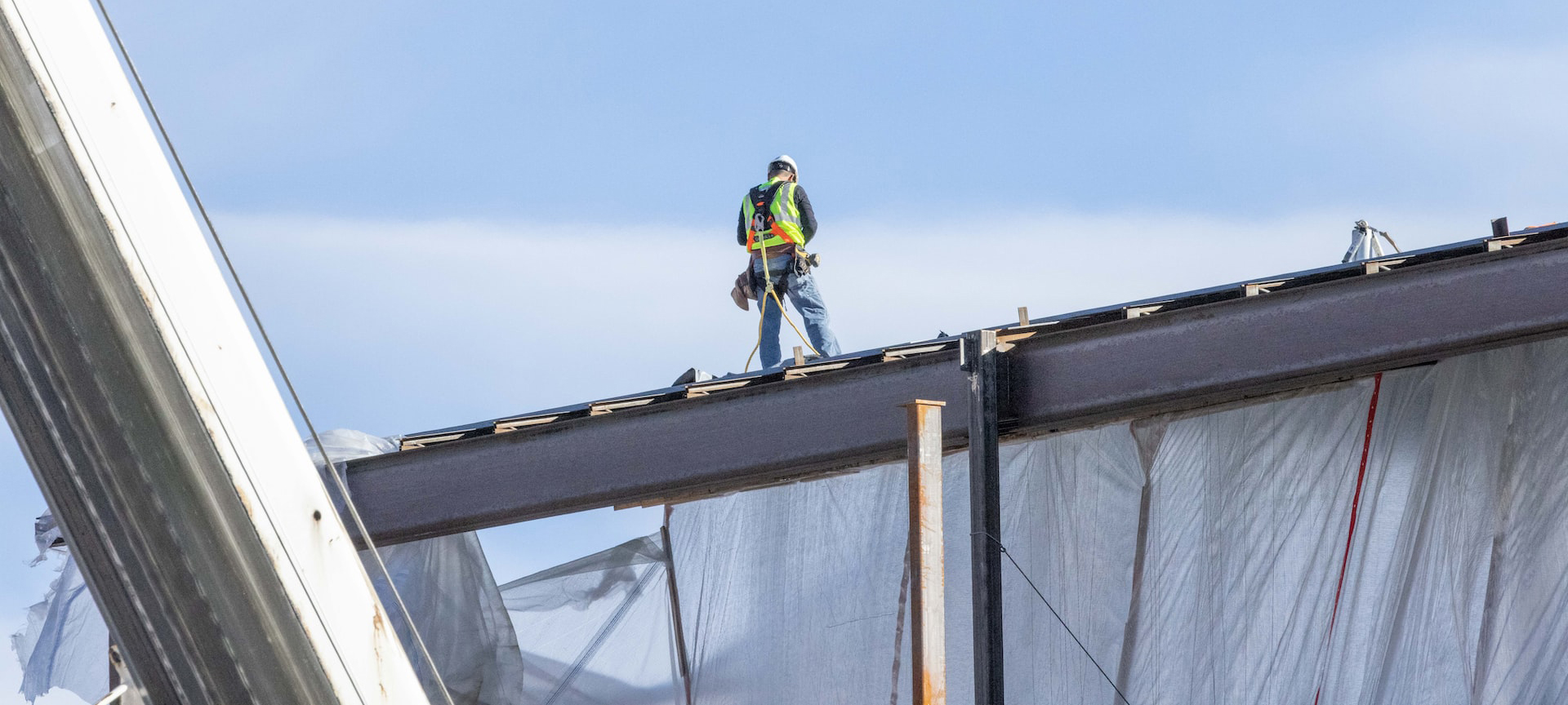 roofer applying replacement commercial roof