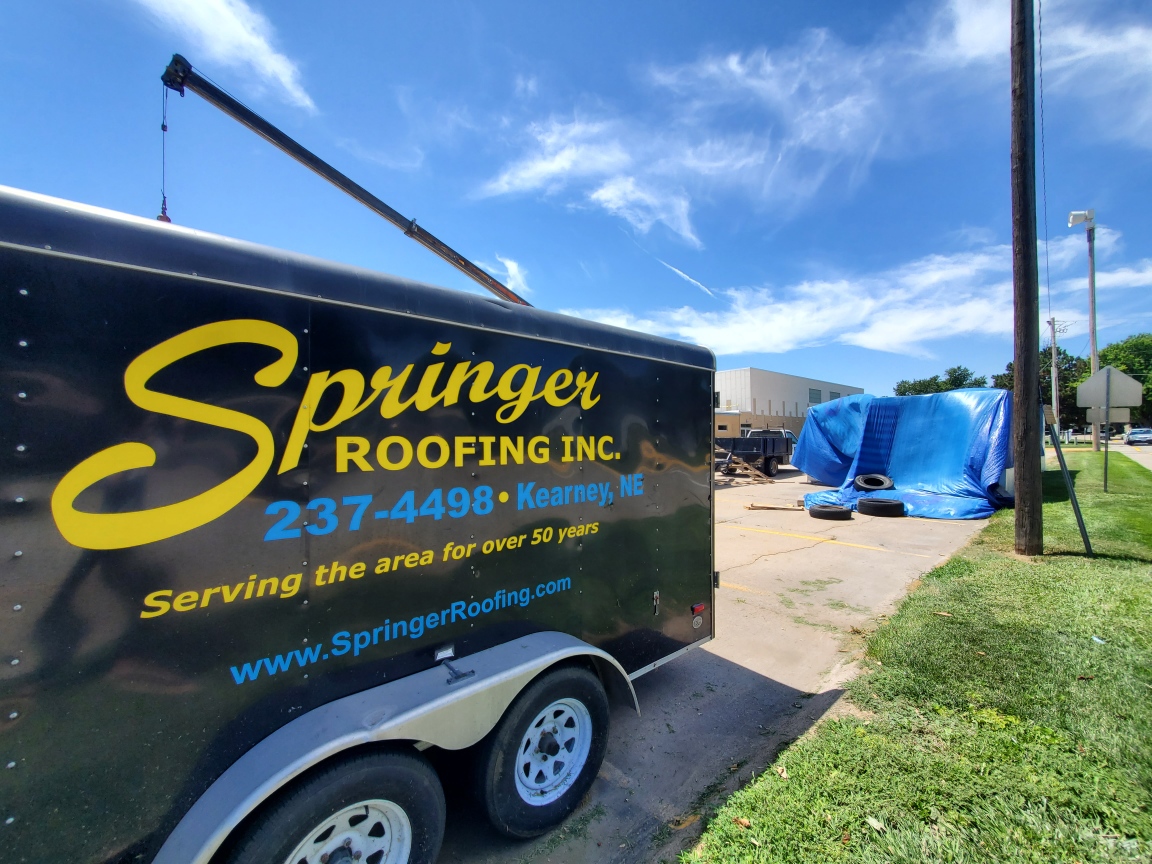 roofer applying replacement commercial roof